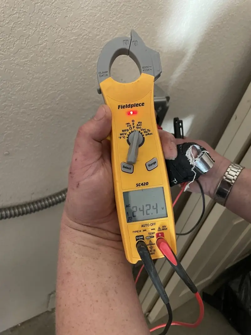 Voltage testing with clamp meter during Whole House Surge Protector in Columbus